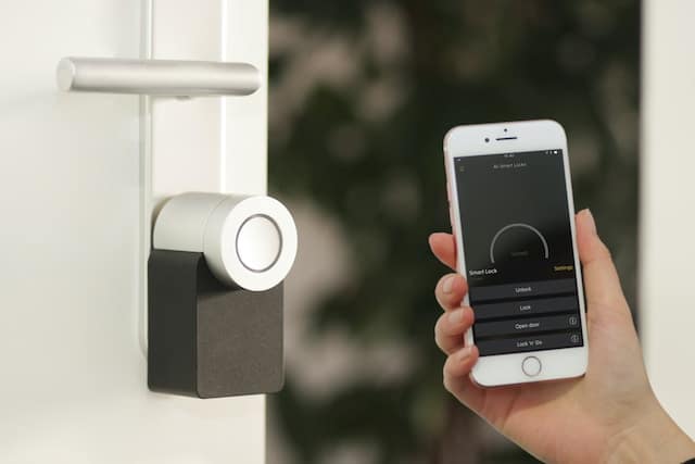 Smart lock on a door underneath the door handle.