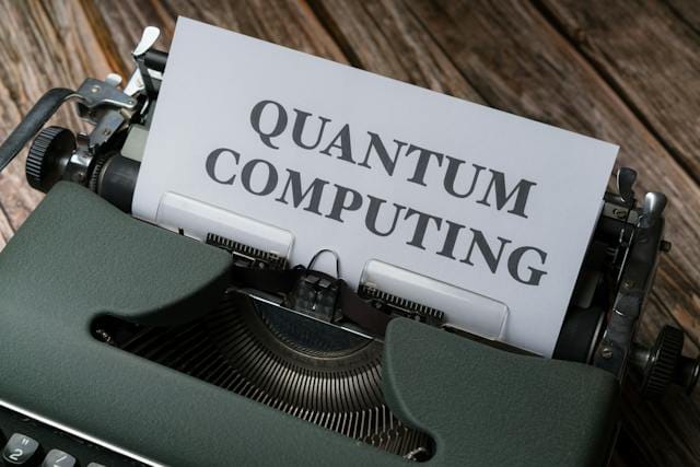 A type writer is sitting on a desk and a sheet of paper is sticking out with the words 