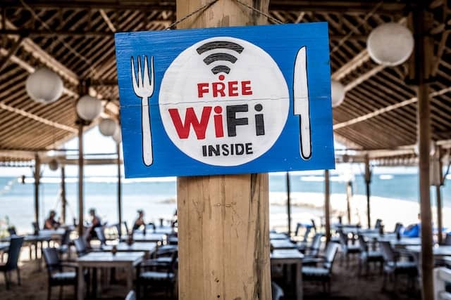 Sign on a post next to a sit-down lounge that reads 