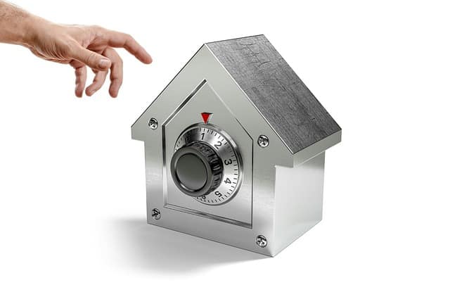 House shaped metal box with a combination dial on the front.