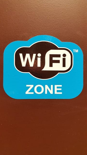Sign on a wall that reads "WiFi Zone"